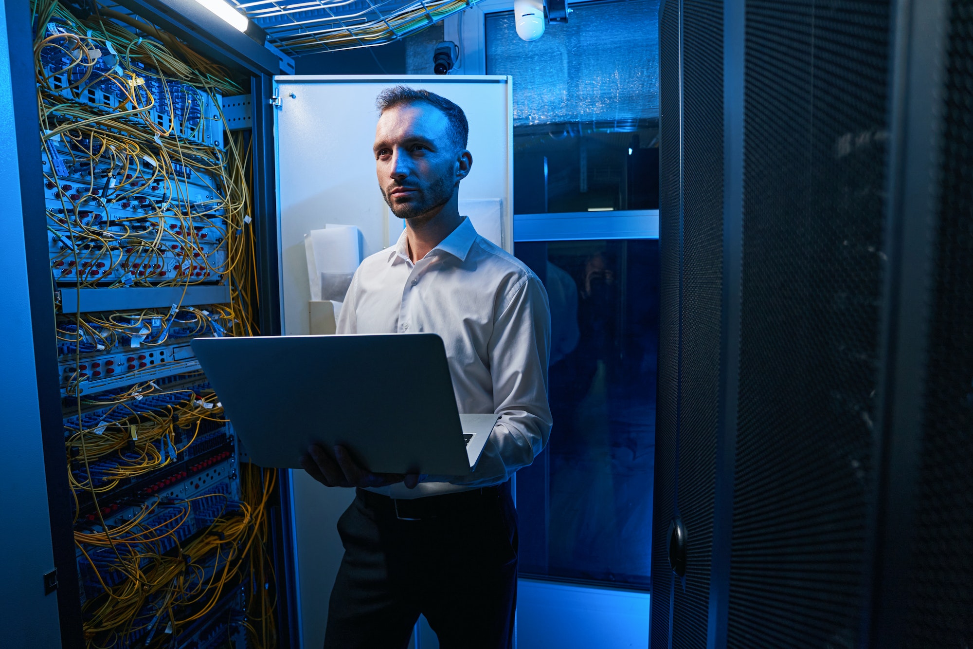 Server administrator doing network maintenance in data center